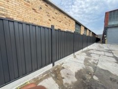 Colorbond fence along a warehouse wall