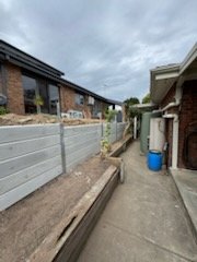 Concrete sleeper wall beside a side path
