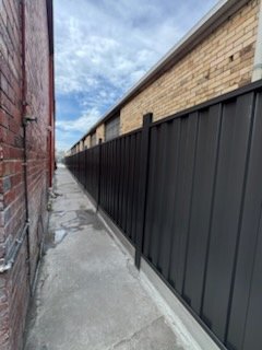 Finished dark Colorbond fence along the same laneway