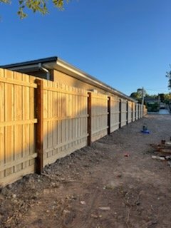 Finished treated pine paling fence along the same home