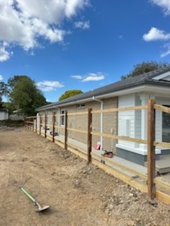 Timber posts and rails set along a new home