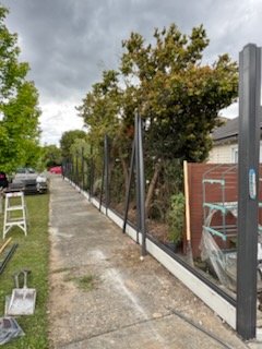 New posts set along a footpath after the old fence came out